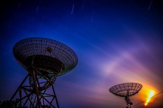 Large radio telescope dishes against an evening sky representing research applications