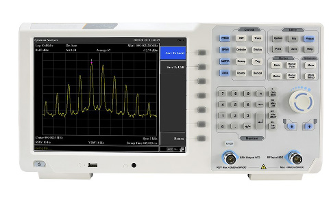 Benchtop instrument front panel showing a multi-peak spectral display, keypad, and rotary control